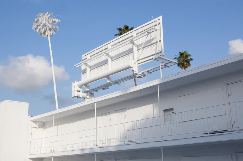 Illustration for article titled Why an Artist Totally Whitewashed This LA Motel—Palm Trees and All